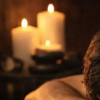 Candles glowing beside the massage table
