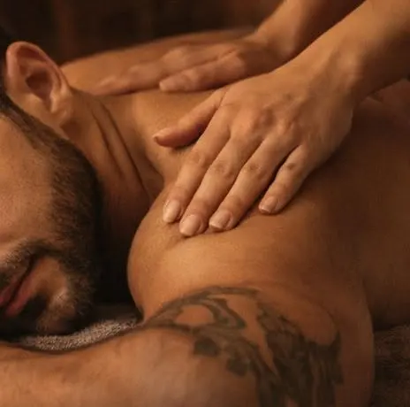 Therapist's hands working the upper back